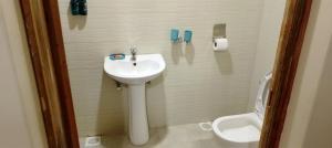 a bathroom with a sink and a toilet at Miliki Maasai Mara in Maasai Mara National Reserve