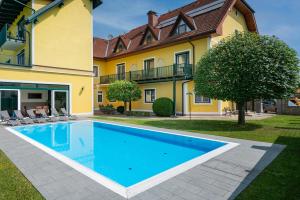 a swimming pool in front of a house at SCHACHENWALD Hotel & Restaurant I Free Parking in Premstätten