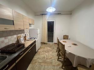 a kitchen with a table and a kitchen with a table and chairs at Apartments Anđelka in Pag