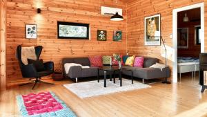 a living room with a couch and a table at Architect-Designed Holiday Home By Isefjord in Kirke-Hyllinge +29 photos