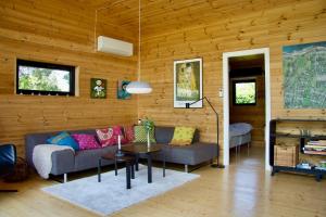 a living room with a couch and a table at Architect-Designed Holiday Home By Isefjord in Kirke-Hyllinge