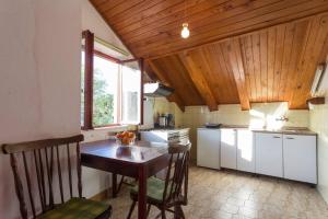 a kitchen with a wooden ceiling and a table with chairs at Beautiful apartment-center of old town in Cavtat in Cavtat
