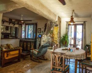a living room with a table and chairs at Trullo of the Living Garden in Ostuni