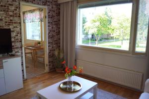 a living room with a vase of flowers on a table at Apartments Borg Annikki in Pori