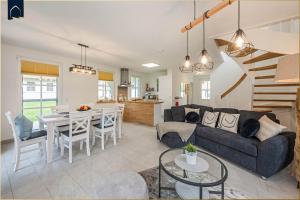 a living room with a couch and a table at Fischerdorf Ferienhaus JoHann in Zirchow