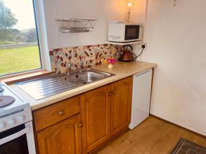 a kitchen with a sink and a microwave at Seaview in Duneen