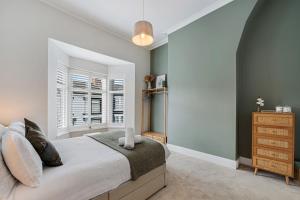 a bedroom with a large bed and a window at Watford Lodge - Air Host & Stay - A Home in the Heart of Anfield in Liverpool