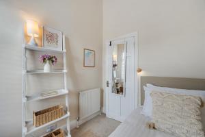 a bedroom with a bed and white shelves at Watford Lodge - Air Host & Stay - A Home in the Heart of Anfield in Liverpool