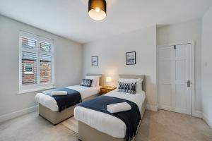 a bedroom with two beds and a window at Watford Lodge - Air Host & Stay - A Home in the Heart of Anfield in Liverpool