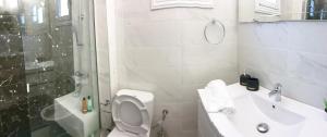a bathroom with a toilet and a sink and a shower at DESIGN HOMe in Paleo Tsifliki