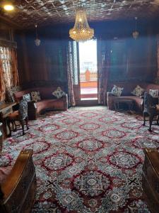 a living room with couches and a large rug at Houseboat Queen Of Africa in Jāmb