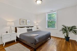a white bedroom with a bed and a window at Newly Updated Vintage 6 Bedroom Single Family Home home in Chicago
