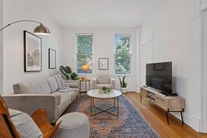 a living room with a couch and a tv at Newly Updated Vintage 6 Bedroom Single Family Home home in Chicago