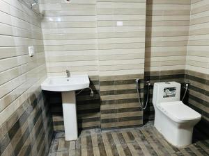 a bathroom with a sink and a toilet at Hotel I Stay in Bengaluru