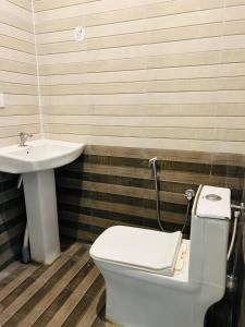 a bathroom with a toilet and a sink at Hotel I Stay in Bengaluru