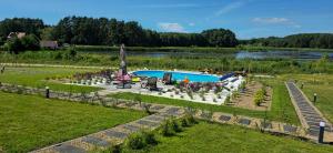 an aerial view of a garden with a pool at Port Stobno - Portowe Domki przy Winnicy in Stobno