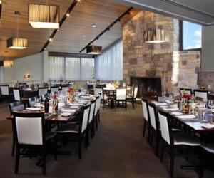 a dining room with tables and chairs and a fireplace at Chauncey Hotel and Conference Center in Princeton +2 photos