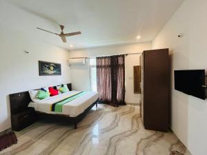 a hotel room with a bed and a window at Hotel I Stay in Bengaluru