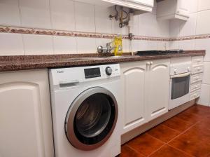 a white washer and dryer in a kitchen at Perfect Room Near Airport 3 in Lisbon
