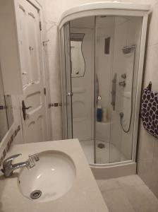 a bathroom with a sink and a shower at Perfect Room Near Airport 3 in Lisbon +8 photos