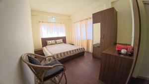 a bedroom with a bed and a dresser and a mirror at Green View Bungalow in Shillong
