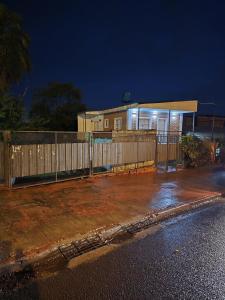 a house with a fence in front of it at Aura Iguazú Apartment in Puerto Iguazú