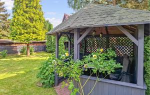 a gazebo with a roof on a yard at 3 Bedroom Awesome Home In Nowe Warpno in Nowe Warpno +19 photos