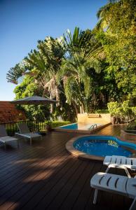 a wooden deck with chairs and a swimming pool at Baan Talay in Salad Beach