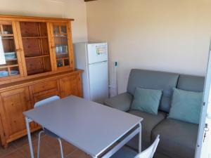 a living room with a couch and a table and a refrigerator at Etxe ttikia in Ahetze