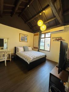 a bedroom with a bed and a flat screen tv at Naval bureaucracy in Kaohsiung