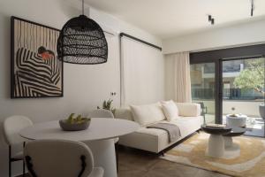 a living room with a white couch and a table at Allegro Suites in Rethymno +42 photos