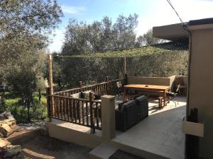 a patio with a wooden table and a wooden fence at La Villa Maquis in Bonifacio +7 photos