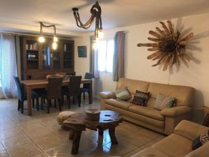 a living room with a couch and a table at La Villa Maquis in Bonifacio