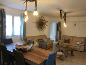 a living room with a table and a couch at La Villa Maquis in Bonifacio