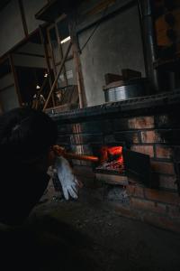 a brick oven with a fire in it at THE Aramaki 日本の魅力と伝統が詰まった築200年の古民家 1日1組限定貸切 in Ō-naka