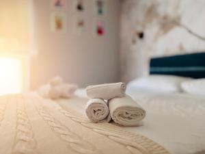 two towels sitting on top of a bed at Oceanomare Beach Home in Bari