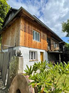 a wooden house with a fence in front of it at Podgórska in Lanckorona