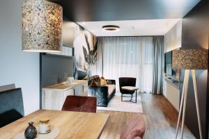 a living room with a table and a couch at Hotel Gasthof Zum Schwanen in Reutte