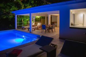 a house with a swimming pool at night at Private Escape Villa near Beach and Shopping in Quartier de Lorient +24 photos