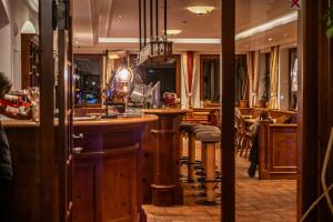 a bar in a restaurant with stools at Schönmoosalm in Krimml