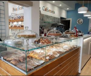 a bakery with a display case filled with pastries at Casa dei Mulini a vento in Trapani