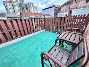 a bench sitting on top of a swimming pool at 26 Rangoon Residence 26 in George Town
