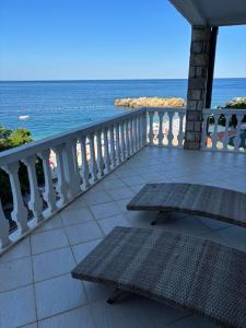 a balcony with benches and a view of the ocean at View 1 in Dobra Voda