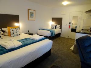 Ένα ή περισσότερα κρεβάτια σε δωμάτιο στο BKs Premier Motel Hamilton