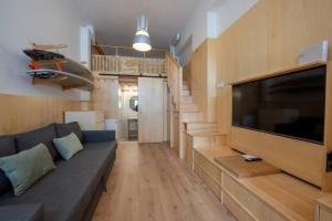 a living room with a couch and a flat screen tv at Suances Surf Beach in Suances