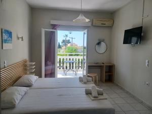 Postel nebo postele na pokoji v ubytování Tassos & Marios Apartments I