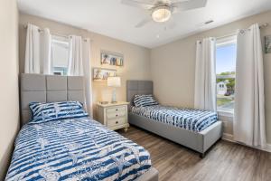 a bedroom with two beds and a window at Masons Beach House Getaway in Kill Devil Hills