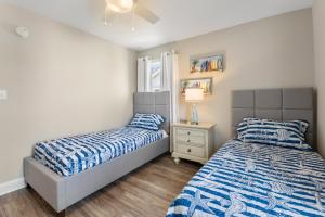 a bedroom with two beds and a window at Masons Beach House Getaway in Kill Devil Hills