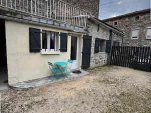 a table and chairs sitting outside of a house at Chaleureuse maisonnette au cœur de Ruoms avec terrasse et parking - FR-1-697-35 in Ruoms