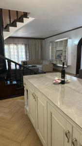 a bottle of wine sitting on a counter in a living room at Greek Mansion in Nea Moudania